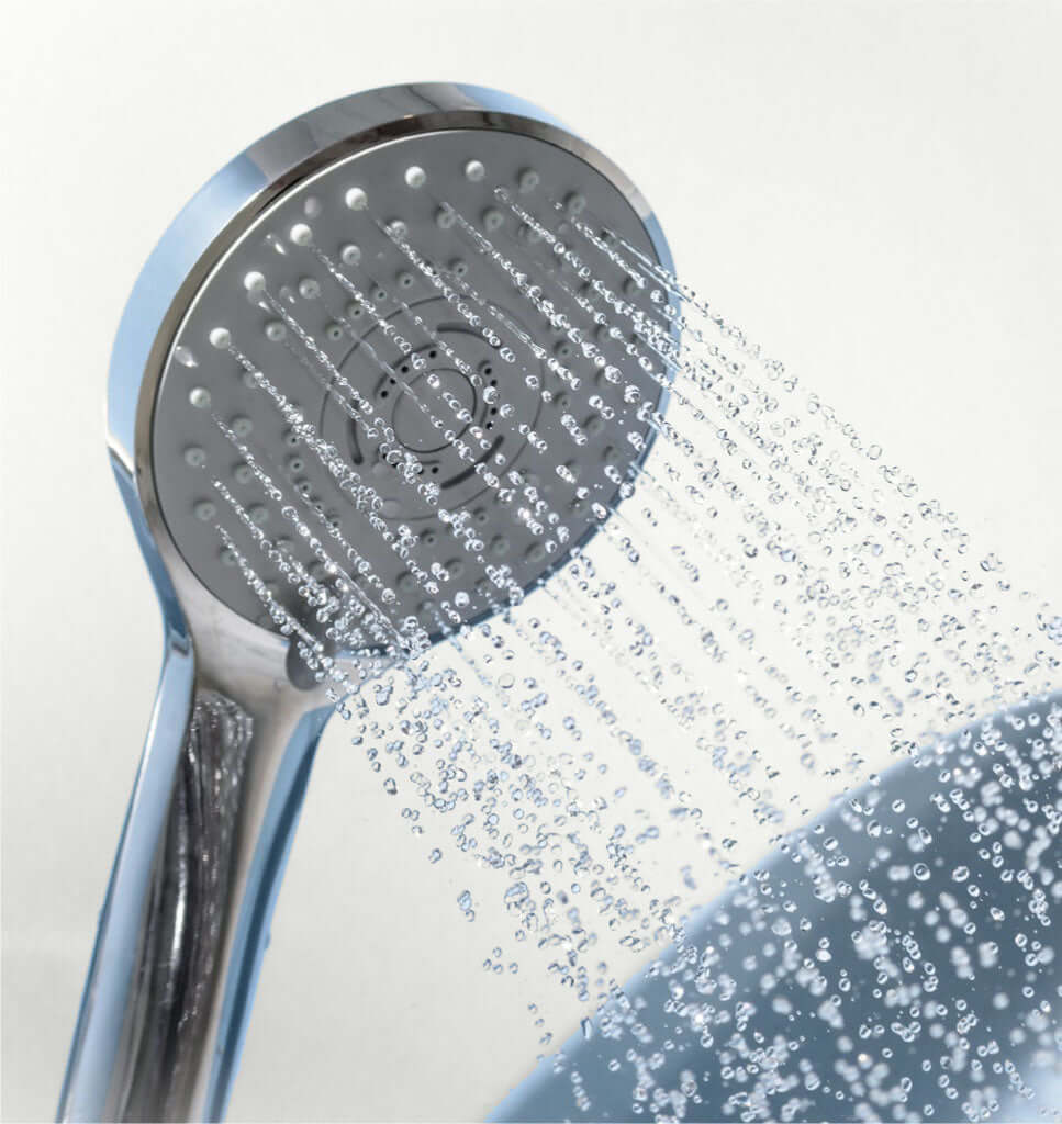 silver shower head with water spraying